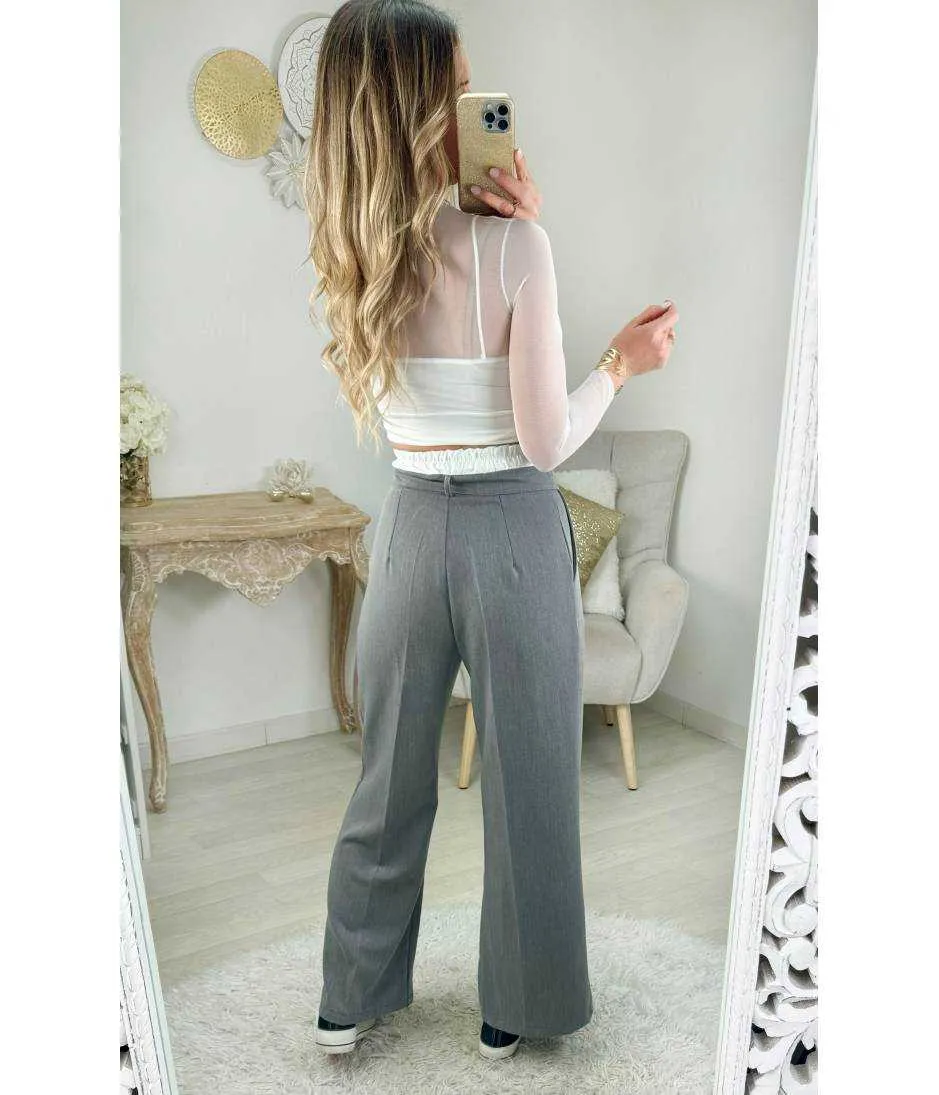 Grey flowy pants with white belt.