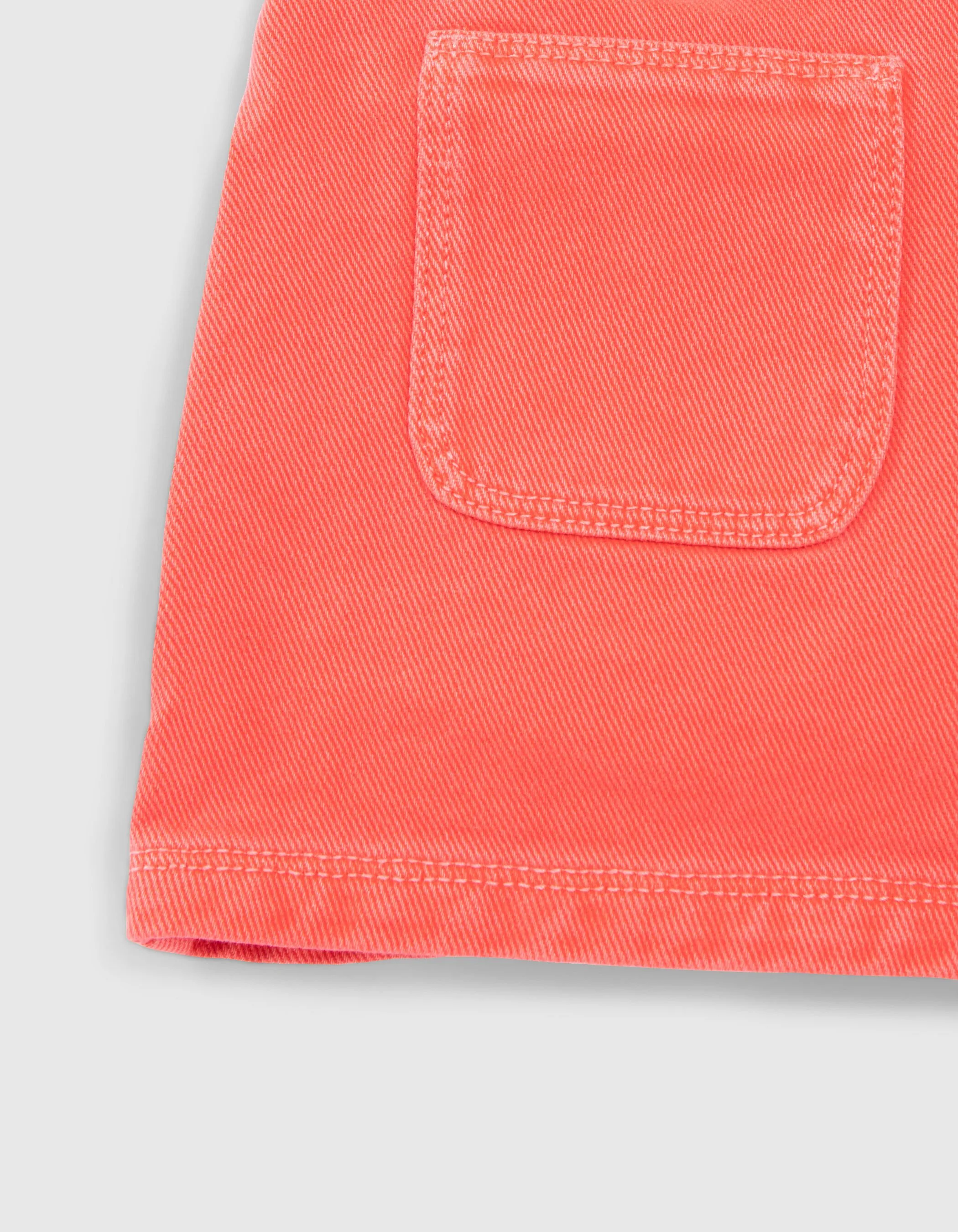 Red upcycled denim shorts with patch pockets for girls.